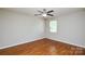 Bedroom features hardwood floors, neutral walls, a ceiling fan, and a window at 5424 Amado St, Charlotte, NC 28215
