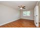 A spacious bedroom with wood floors, a ceiling fan, and natural light at 5424 Amado St, Charlotte, NC 28215