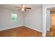 Well-lit bedroom features hardwood floors, neutral walls, and a ceiling fan at 5424 Amado St, Charlotte, NC 28215