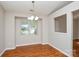 Bright dining room with hardwood floors, a modern chandelier and a large window at 5424 Amado St, Charlotte, NC 28215