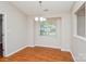 Bright dining room with hardwood floors, a modern chandelier and a large window at 5424 Amado St, Charlotte, NC 28215