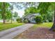 Exterior view of a home featuring a long driveway and beautifully maintained landscaping at 5424 Amado St, Charlotte, NC 28215