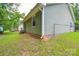 A side view of the home, featuring green siding and a fenced in yard at 5424 Amado St, Charlotte, NC 28215