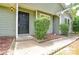 Close-up of a house facade with the address visible above a welcoming black front door at 5424 Amado St, Charlotte, NC 28215