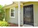 View of the black front door and siding of a home at 5424 Amado St, Charlotte, NC 28215