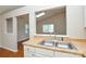 Eat-in kitchen with a stainless steel double sink, neutral countertop and access to other rooms at 5424 Amado St, Charlotte, NC 28215