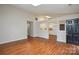 Spacious living room featuring wood floors and a view to the bright kitchen at 5424 Amado St, Charlotte, NC 28215