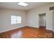 Living room with wood floors, bright window, and neutral wall paint at 5424 Amado St, Charlotte, NC 28215