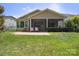 A spacious backyard features a screened patio and a well-maintained lawn at 5524 Elk Knob Ct, Denver, NC 28037