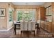 Dining room offers elegant furniture, a modern chandelier, and views of the landscaped outdoors at 5524 Elk Knob Ct, Denver, NC 28037