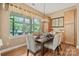 Well-lit dining room features a bay window overlooking outdoor scenery and a modern chandelier at 5524 Elk Knob Ct, Denver, NC 28037