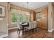 Dining room features hardwood floors, a large window with natural light, and built-in cabinets at 5524 Elk Knob Ct, Denver, NC 28037