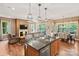 Open kitchen featuring a breakfast bar and seamlessly connecting to the living and dining areas at 5524 Elk Knob Ct, Denver, NC 28037