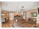 Open-concept living room features hardwood floors, seamlessly connecting to the kitchen and dining areas at 5524 Elk Knob Ct, Denver, NC 28037
