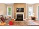 Cozy living room features a fireplace with decorative mantel, complemented by hardwood floors and natural light at 5524 Elk Knob Ct, Denver, NC 28037