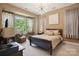 Inviting main bedroom showcasing bay windows, a decorative chandelier, and comfortable sitting area at 5524 Elk Knob Ct, Denver, NC 28037