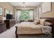 Relaxing main bedroom with decorative pillows, bay windows overlooking the yard, and dark furniture at 5524 Elk Knob Ct, Denver, NC 28037