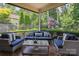 Inviting screened porch featuring comfortable seating and lush, landscaped surroundings at 5524 Elk Knob Ct, Denver, NC 28037
