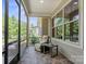 Screened porch with brick floors, relaxing chair, and a view of the well-maintained yard at 5524 Elk Knob Ct, Denver, NC 28037