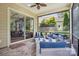 Relaxing screened porch features comfortable seating, brick floors, and views of the yard at 5524 Elk Knob Ct, Denver, NC 28037