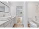 Modern bathroom featuring a vessel sink, white cabinets, and a combined tub and shower at 5728 Mantario Dr, Charlotte, NC 28269
