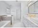 Modern bathroom featuring double sinks, a soaking tub, and sleek, neutral finishes at 5728 Mantario Dr, Charlotte, NC 28269