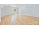 Spacious and bright bedroom featuring hardwood floors, a ceiling fan, and a white door at 5728 Mantario Dr, Charlotte, NC 28269