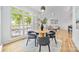 Bright dining area with a table near large windows and an adjacent living space at 5728 Mantario Dr, Charlotte, NC 28269
