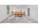 Well-lit dining room showcases a wooden dining set and stylish rug, exuding modern elegance at 5728 Mantario Dr, Charlotte, NC 28269