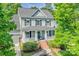 Inviting two-story home with lush green trees and a classic front porch at 5728 Mantario Dr, Charlotte, NC 28269