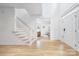 Welcoming foyer with hardwood floors, staircase, and ample natural light at 5728 Mantario Dr, Charlotte, NC 28269