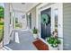 Cozy front porch featuring a decorated front door, plants, and a welcoming atmosphere at 5728 Mantario Dr, Charlotte, NC 28269