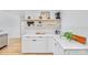 Bright kitchen featuring floating shelves, white cabinets, and clean countertops at 5728 Mantario Dr, Charlotte, NC 28269