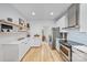 Modern kitchen with stainless steel appliances, and floating shelves, with views to dining at 5728 Mantario Dr, Charlotte, NC 28269