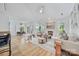 Bright, open living room with hardwood floors, fireplace, and views into dining area at 5728 Mantario Dr, Charlotte, NC 28269