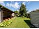A view of a lovely backyard featuring a well-kept lawn and lush foliage, plus a covered deck at 5806 Autumn Trace Ln, Indian Trail, NC 28079