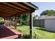 This backyard includes a covered porch and a wooden fence at 5806 Autumn Trace Ln, Indian Trail, NC 28079