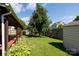 Backyard featuring a covered porch, wooden fence, and lush green grass at 5806 Autumn Trace Ln, Indian Trail, NC 28079