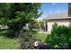 Lush backyard with a black metal fence, landscaping, and a view of an arbor at 5806 Autumn Trace Ln, Indian Trail, NC 28079
