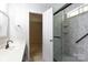 Bathroom featuring vanity, decorative mirror, doorway to bedroom, and tiled shower at 5806 Autumn Trace Ln, Indian Trail, NC 28079