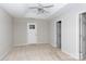 Bedroom featuring a trey ceiling, ceiling fan, neutral carpet, and a door to the exterior at 5806 Autumn Trace Ln, Indian Trail, NC 28079