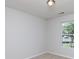 This bedroom features neutral walls, carpet, and a bright window at 5806 Autumn Trace Ln, Indian Trail, NC 28079