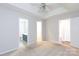 Spacious bedroom with neutral carpet, ceiling fan, and multiple doors, offering ample space and natural light at 5806 Autumn Trace Ln, Indian Trail, NC 28079