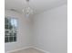 This bedroom is brightly lit by a hanging chandelier and window view at 5806 Autumn Trace Ln, Indian Trail, NC 28079