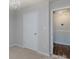 This bedroom has neutral-colored walls, a chandelier, and two white doors at 5806 Autumn Trace Ln, Indian Trail, NC 28079