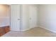 This bedroom features carpeted floors, two white doors, and neutral walls at 5806 Autumn Trace Ln, Indian Trail, NC 28079