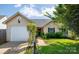 Charming home with a well-manicured lawn, attached garage, and sidewalk at 5806 Autumn Trace Ln, Indian Trail, NC 28079