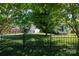 Charming home featuring lush lawn, decorative fence and mature trees at 5806 Autumn Trace Ln, Indian Trail, NC 28079