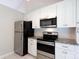 Modern kitchen with stainless steel appliances, granite countertops and white cabinets at 5806 Autumn Trace Ln, Indian Trail, NC 28079