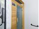 Close up of the electric sauna with a glass door and a wooden interior at 5806 Autumn Trace Ln, Indian Trail, NC 28079